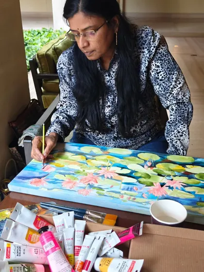 Here I am, completely absorbed in a live painting session at the ITC Gardenia hotel. I am creating a colorful lotus pond canvas, surrounded by the beautiful greenery of the hotel.