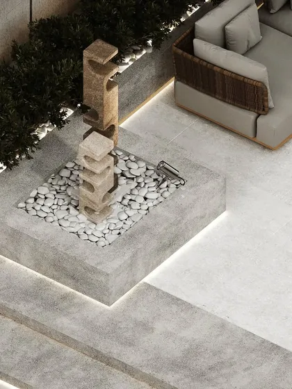 A detail shot of a sculptural water feature and stone art piece, adding an artistic and tranquil element to the rooftop design.