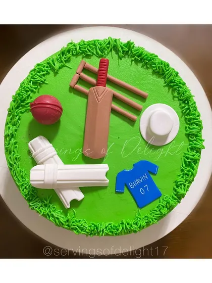 Another look at my cricket theme cake, this time with fondant pads, a jersey, and a hat. All the elements are handcrafted and completely edible.
