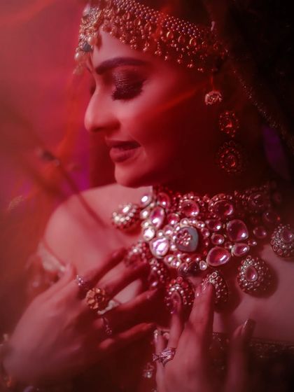 An artistic, soft-focus portrait of a bride, with a red filter creating a dreamy and romantic mood.