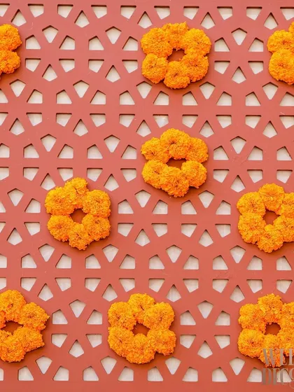 A close-up of the custom jali panel, with marigold florets placed within the geometric patterns. This was a unique way to integrate florals directly into the structural decor.
