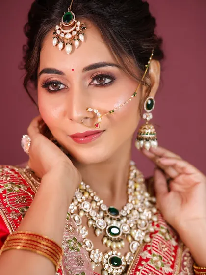 This angle highlights the intricate maang tikka and the perfectly sculpted cheekbones.