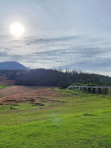 A vast, open landscape with rolling hills under a bright sun. Our trips offer a variety of stunning natural views.