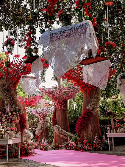 This floral wonderland was designed for a lavish daytime event. We used sculptural floral trees and hanging lace lanterns to create a breathtaking path, where every detail whispers tales of beauty and enchantment.