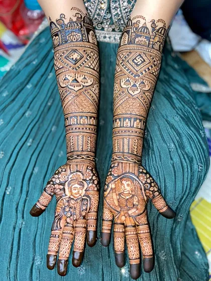 A beautiful depiction of a royal bride and groom. The portraits are the centerpiece, surrounded by detailed patterns and auspicious symbols like the swastika.