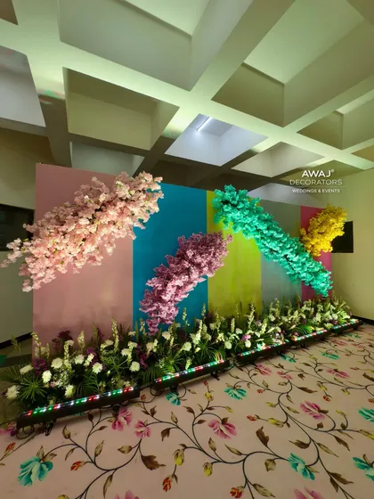Another angle of the pastel photo wall, showing the floral carpet that ties the whole look together.