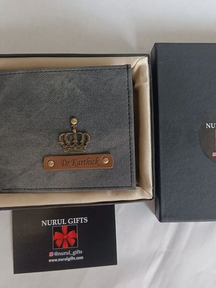 A grey denim wallet customized for 'Dr. Karthick' with a crown charm.