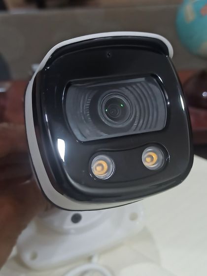 A close-up of the lens and dual spotlights on a color night vision camera. This technology is a game-changer for identifying details like clothing or car color at night.