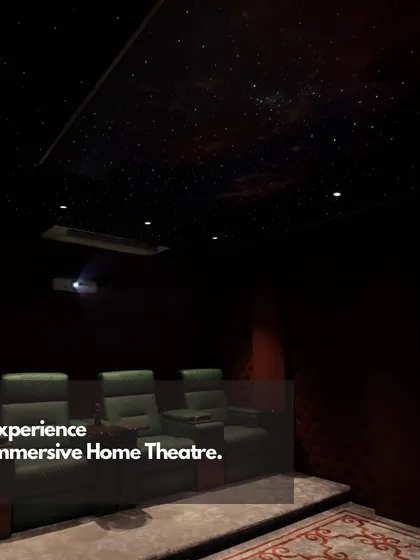 A look into our experience center's home theater, where clients can feel the power of an immersive setup. The room features premium recliners, a projector, and a starlight ceiling.