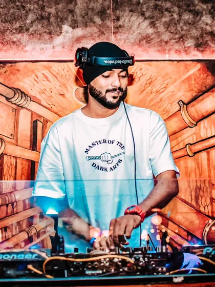 Focused and in the zone. Behind the decks, it's all about the hustle and delivering a technically perfect set on my Pioneer DJ console. This is where I blend tracks, read the crowd, and make the magic happen.