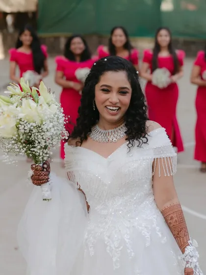 Pure happiness with her bridesmaids. Her makeup is fresh and vibrant, matching the joyful energy of the day.