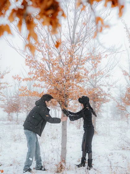 A quiet, shared moment in a snowy forest in Azerbaijan. This photo captures the couple interacting with nature, creating a serene and intimate portrait that feels both personal and picturesque.