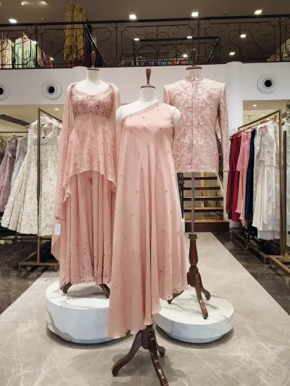 Soft pastels are a refined choice for daytime ceremonies. This blush pink sherwani on display features delicate embroidery, demonstrating a softer approach to groom's wear.