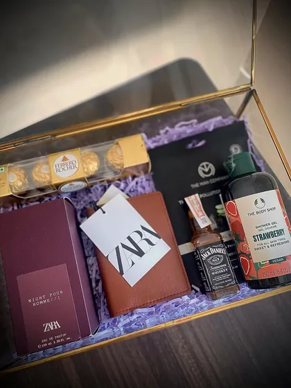 This luxury gift hamper is perfect for a special someone, featuring a Zara perfume and wallet, a Body Shop shower gel, a Jack Daniel's miniature, and a face mask.