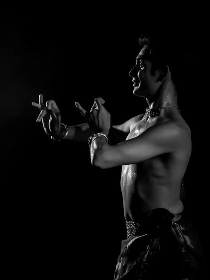 A black and white profile shot, highlighting the expressive potential of the hands and face in a moment of quiet intensity.