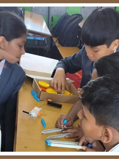Teamwork in action. A group of boys works together to assemble their robot, showing how our workshops encourage collaboration and peer-to-peer learning.