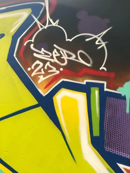 A detail of my 'ZERO 23' tag on a piece. Tagging is the foundation of graffiti culture, and it's a signature I leave on all my work, big or small.