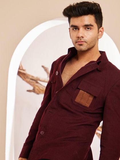 This portrait showcases how the maroon shacket frames the upper body. The open collar style offers a relaxed feel, while the structured shoulders maintain a sharp silhouette.