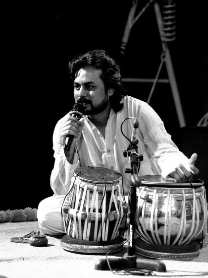 A black and white photo of me speaking to the audience during a concert.