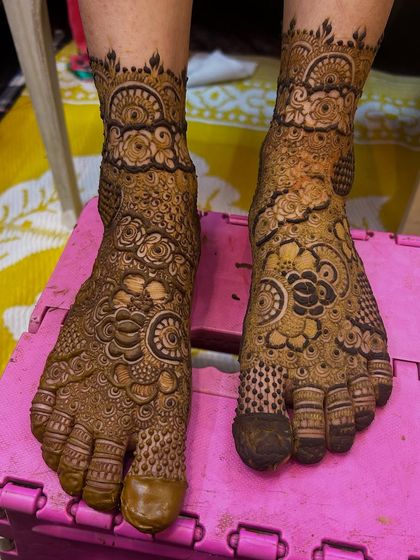 A heavy and intricate design for the legs. The patterns are a mix of floral and traditional motifs, with full coverage.