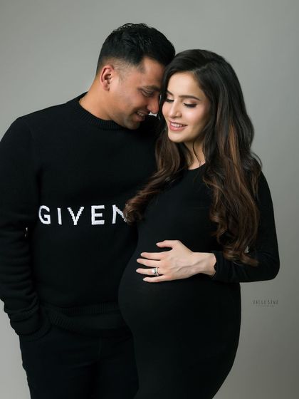 A quiet, loving moment between a couple during their black and white maternity session. The image feels both classic and contemporary.