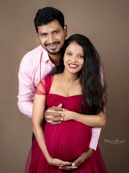 A bright and happy couple's portrait. Their beaming smiles are infectious and perfectly capture the joy of expecting.