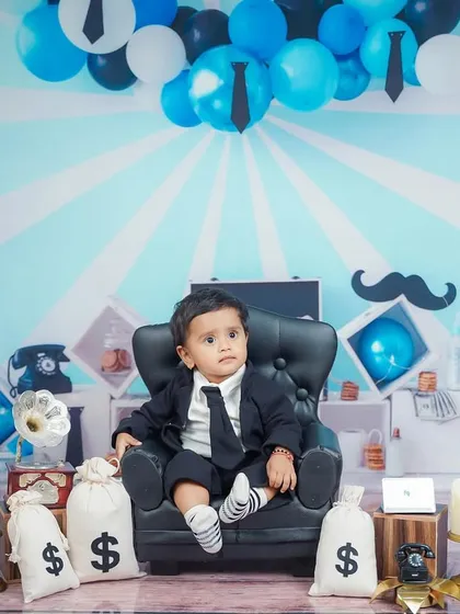 Surveying his empire. The full Boss Baby setup includes a custom backdrop and lots of fun, themed props.