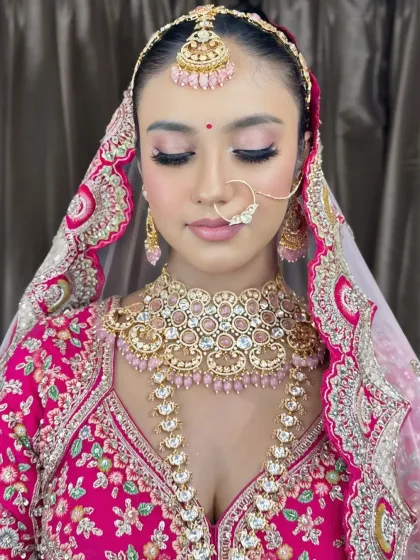The full look with the dupatta. The soft pink makeup perfectly complements her vibrant pink lehenga.
