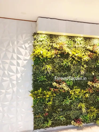 An indoor vertical garden installed against a 3D textured wall, with integrated lighting to highlight the various shades and textures of the faux foliage.
