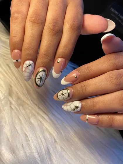 Vacation nails with a touch of finesse. We created a white crocodile skin effect and combined it with hand-painted compass designs for a unique and adventurous look.