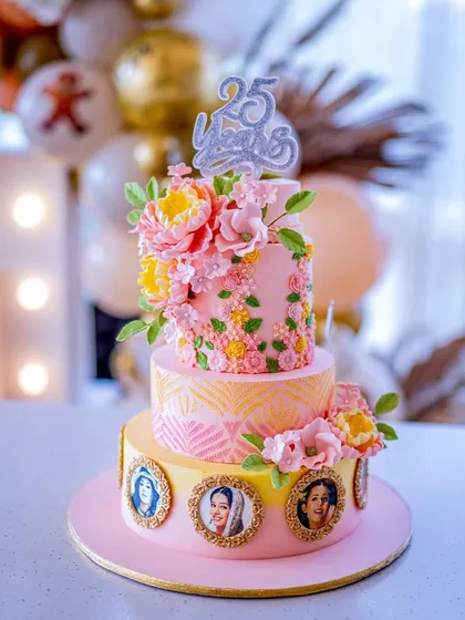 A closer look at the stunning three-tier cake for a triple celebration, including a career milestone for a film star. The cake features edible photo frames and is decorated with handcrafted pink and yellow sugar peonies.