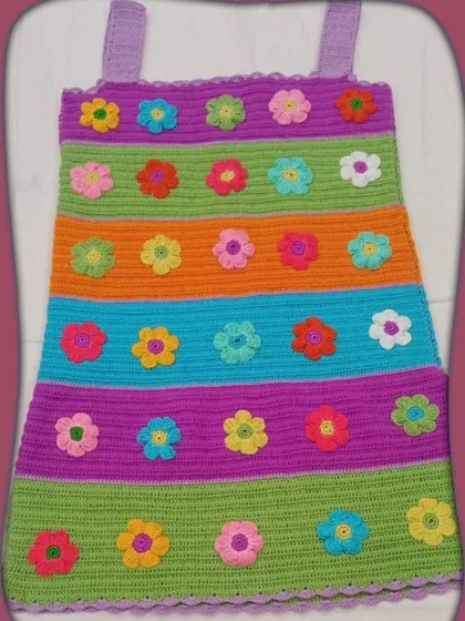 Beyond small embellishments, I also take on full apparel projects like this custom-made crochet dress. Adorned with colorful flower appliqués, it showcases the detailed craftsmanship I bring to larger, bespoke pieces.