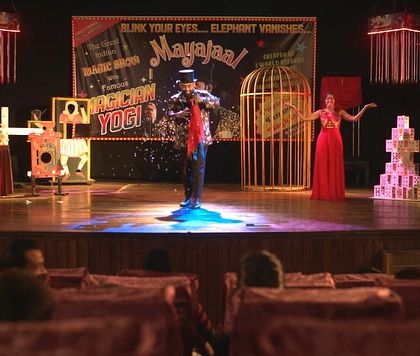 A wide shot of the 'Mayajaal' magic show set for the web series. We used classic props like the birdcage and various illusion boxes to create an authentic feel.