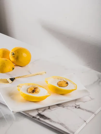 When life gives you lemons, we make dessert. This playful creation looks exactly like a lemon but is actually a delicate sweet, showcasing our passion for Indian fusion desserts that surprise and delight the senses.