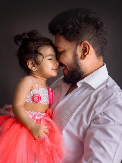 A sweet nose-to-nose moment between a father and his little girl. The dark background and their bright smiles make this an incredibly heartwarming shot.