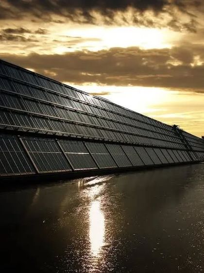 A solar canal project at dusk, showcasing an innovative approach to land and water conservation. By covering canals with solar panels, we can generate clean energy while reducing water evaporation, a key benefit in arid regions.