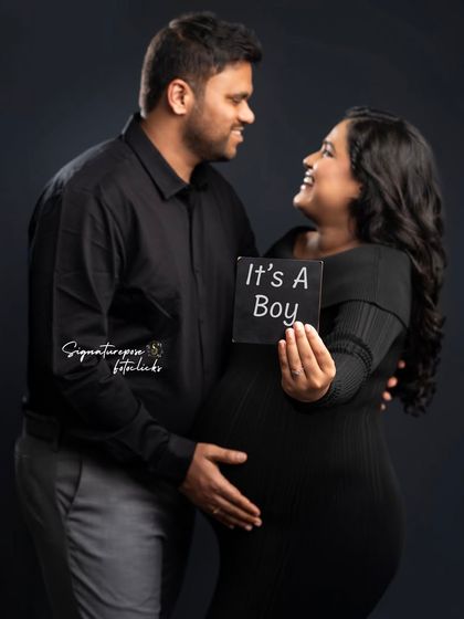A sweet gender reveal moment for a baby boy, captured in a classic studio setting.