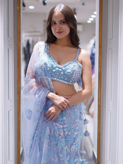 Dive into the magic of the night sky with this celestial blue fishtail lehenga, shimmering like stars.