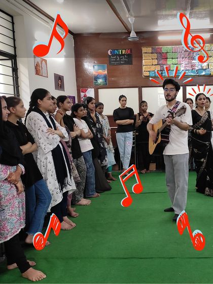 An instructor plays guitar while students sing along. We believe in learning by doing, and our sessions are filled with opportunities for children to practice and perform together.