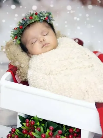 Santa's most adorable Christmas present. This newborn is sleeping peacefully in a sleigh, surrounded by a snowy, magical scene.
