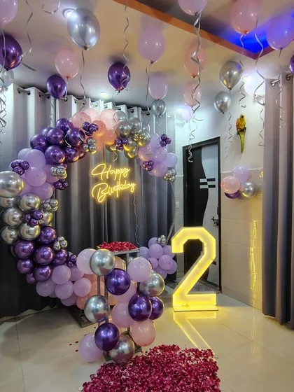 The complete room setup for the 2nd birthday, with the balloon ring, marquee number, and floor decorations.