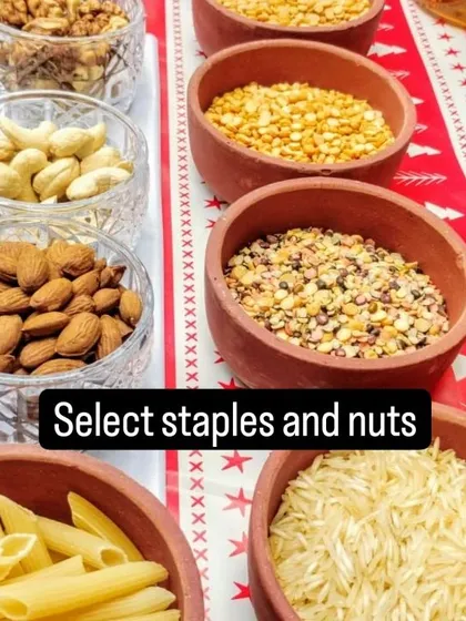 A display of various staples and nuts, including pasta, rice, lentils, almonds, and cashews.