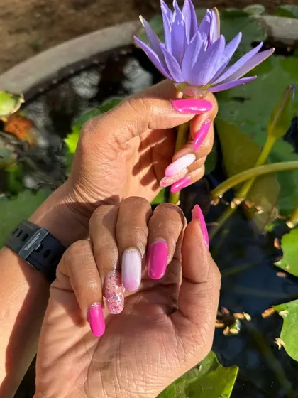 Festive nails created for a family wedding. This set features different shades of pink, an ombré effect, and a sparkling glitter accent nail.