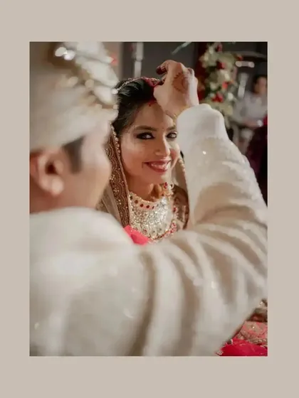 A close-up of the sindoor ceremony, a deeply significant and emotional moment for the couple.