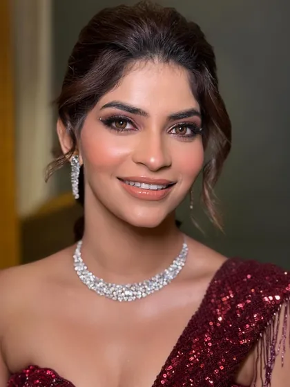 A close-up of the engagement look, where the soft updo perfectly balances the glamorous makeup and sparkling diamond necklace.