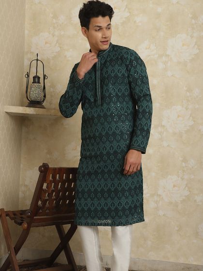 A full view of the dark green embroidered kurta. It's a breezy, light, and stylish set that keeps you cool while looking hot.
