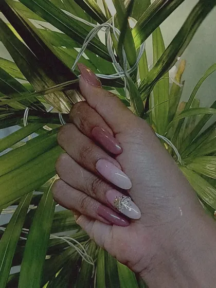 A stylish multi-tonal look using shades of mauve and pink, with a single glitter and rhinestone accent nail.