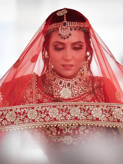 A bridal portrait is more than just a photo; it's a timeless keepsake. I focus on capturing the bride's elegance and anticipation, using the traditional red veil to create a classic, intimate, and powerful image.