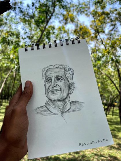 The Kuvempu sketch, held up in nature, reflecting the poet's deep connection to the environment.