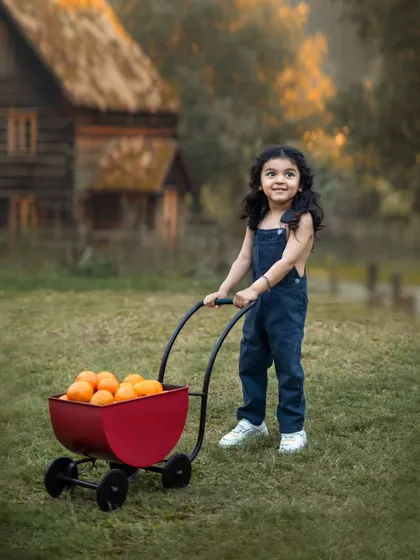 This little one is ready to transport his oranges in a cute red wagon. Themed shoots allow for storytelling and capturing kids at play.